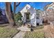 Charming stucco home with a green door and mature landscaping at 2339 S Adams St, Denver, CO 80210