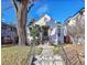 Charming stucco home with a green door and mature landscaping at 2339 S Adams St, Denver, CO 80210