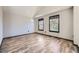 Bright bedroom featuring wood-look flooring, neutral walls and two large windows at 17652 E Temple Dr, Aurora, CO 80015