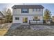 Back exterior featuring neutral siding, windows, and a sliding door to the backyard at 254 Ellendale St, Castle Rock, CO 80104