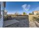 Large, flat backyard with a concrete patio, wooden fence, and ample space for outdoor activities at 254 Ellendale St, Castle Rock, CO 80104
