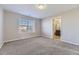 A bedroom with a window offers a view of the neighborhood, featuring neutral carpet and light-filled space at 254 Ellendale St, Castle Rock, CO 80104