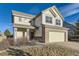 Charming two-story home boasts a lovely exterior with a well-manicured lawn and attached two car garage at 254 Ellendale St, Castle Rock, CO 80104