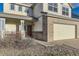 Welcoming home featuring a charming front porch, landscaped yard, and a two-car garage with brick accents at 254 Ellendale St, Castle Rock, CO 80104