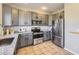 Well-lit kitchen with stainless steel appliances, granite countertops, and sleek gray cabinetry at 254 Ellendale St, Castle Rock, CO 80104