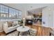 Cozy living room featuring a fireplace, with views into the kitchen featuring dark cabinetry and stainless appliances at 254 Ellendale St, Castle Rock, CO 80104
