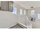 A cozy staircase leading to the upper level, featuring white railings and an abundance of natural light at 254 Ellendale St, Castle Rock, CO 80104