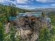 Majestic mountain home with a green roof, surrounded by trees and stunning mountain views at 5699 Northwood Dr, Evergreen, CO 80439