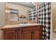Bathroom with a vanity, mirror and a shower with a buffalo check curtain at 5699 Northwood Dr, Evergreen, CO 80439