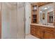 Bathroom showcasing a glass door shower, and wooden vanity with granite countertops at 5699 Northwood Dr, Evergreen, CO 80439