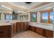Bright bathroom with a double vanity, bathtub and stunning mountain views at 5699 Northwood Dr, Evergreen, CO 80439