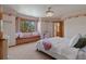 Cozy bedroom with a window seat, plush bedding, and decorative wallpaper at 5699 Northwood Dr, Evergreen, CO 80439