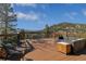 Deck with outdoor furniture, a mountain view, and wood flooring at 5699 Northwood Dr, Evergreen, CO 80439