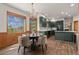 An elegant dining room with mountain views, a chandelier, and hardwood floors connected to the kitchen at 5699 Northwood Dr, Evergreen, CO 80439