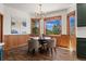 An elegant dining room with mountain views, a chandelier, and hardwood floors at 5699 Northwood Dr, Evergreen, CO 80439