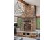 Close up of a stunning stone fireplace with wood accents and inset windows at 5699 Northwood Dr, Evergreen, CO 80439