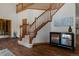 Grand foyer with a beautiful wooden staircase, hardwood floors, and modern decor at 5699 Northwood Dr, Evergreen, CO 80439