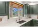 A sink and countertop area, and an expansive window with a mountain view at 5699 Northwood Dr, Evergreen, CO 80439