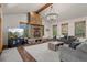 Comfortable living room with a striking stone fireplace, hardwood floors, and mountain views at 5699 Northwood Dr, Evergreen, CO 80439