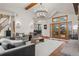 Spacious living room with an open floor plan, fireplace, and seamless access to outdoor views at 5699 Northwood Dr, Evergreen, CO 80439