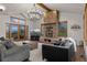Stunning living room featuring a fireplace, vaulted ceilings, and natural light at 5699 Northwood Dr, Evergreen, CO 80439