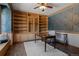 A home office with built-in bookshelves, a desk, and a decorative ceiling fan at 5699 Northwood Dr, Evergreen, CO 80439