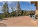 Large patio area with chairs and outdoor grill, perfect for entertaining while enjoying mountain views at 5699 Northwood Dr, Evergreen, CO 80439
