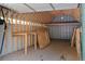 Interior view of the open shed featuring a workbench, ample storage, and natural light at 5699 Northwood Dr, Evergreen, CO 80439