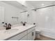 Modern bathroom with double vanity, white tile, and black fixtures at 574 Penn Rd, Elizabeth, CO 80107