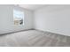 Bright bedroom with a large window and neutral carpet at 574 Penn Rd, Elizabeth, CO 80107