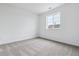 Simple bedroom design with a single window and neutral carpet at 574 Penn Rd, Elizabeth, CO 80107