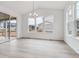 Open dining area with large windows and sliding glass door to a patio at 574 Penn Rd, Elizabeth, CO 80107