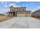 Two-story home with stone accents, three-car garage, and large concrete driveway at 574 Penn Rd, Elizabeth, CO 80107