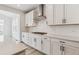 Bright, white kitchen featuring stainless steel appliances and subway tile backsplash at 574 Penn Rd, Elizabeth, CO 80107