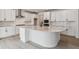 Modern kitchen with white cabinets, large island, and stainless steel appliances at 574 Penn Rd, Elizabeth, CO 80107
