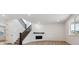 Open living space with stairway, fireplace, and neutral walls at 574 Penn Rd, Elizabeth, CO 80107