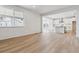 Open floor plan with light wood floors and connection to the kitchen at 574 Penn Rd, Elizabeth, CO 80107