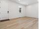 Bright room with light wood floors, white walls, and an accent window at 574 Penn Rd, Elizabeth, CO 80107