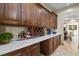 Elegant bar area with custom wood cabinetry and quartz countertops at 634 County Road 37, Brighton, CO 80603