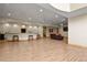 Spacious basement featuring a long bar area with stools, recessed lighting, and laminate flooring at 634 County Road 37, Brighton, CO 80603