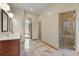 Spacious bathroom with tiled floor, a double vanity, and a glass-enclosed shower at 634 County Road 37, Brighton, CO 80603