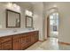 Bathroom with double vanity, dark cabinetry, and stone tile flooring at 634 County Road 37, Brighton, CO 80603