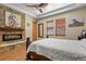 Bedroom with stone fireplace, hardwood floors, and windows with wood blinds at 634 County Road 37, Brighton, CO 80603