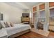 Inviting bedroom featuring a stone fireplace, built-in desk, and hardwood floors at 634 County Road 37, Brighton, CO 80603