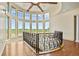 Foyer boasts large curved windows showcasing a green field view and a black metal handrail at 634 County Road 37, Brighton, CO 80603