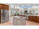 Open concept kitchen with stainless steel appliances, center island, and adjacent dining area at 634 County Road 37, Brighton, CO 80603