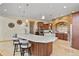 Gourmet kitchen featuring a large island, custom cabinetry, and high-end appliances at 634 County Road 37, Brighton, CO 80603