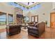 Bright living room with stone fireplace, high ceilings, and leather furniture at 634 County Road 37, Brighton, CO 80603
