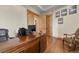 This office boasts a large wooden desk, wooden floors, and natural wood trim and doors at 634 County Road 37, Brighton, CO 80603