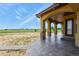 Covered patio with stone columns offers expansive views of the surrounding landscape at 634 County Road 37, Brighton, CO 80603